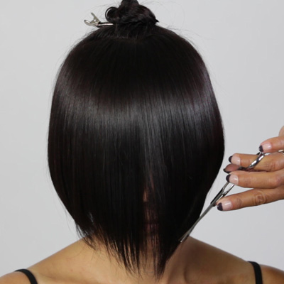 Slice into the fringe at the natural fall in order to connect the previous lengths while creating the desired outline and weight removal.