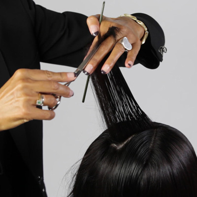 Lift hair 90 degrees and cut from shorter in the back to longer in the front, creating a concave layer that helps remove weight while maintaining length