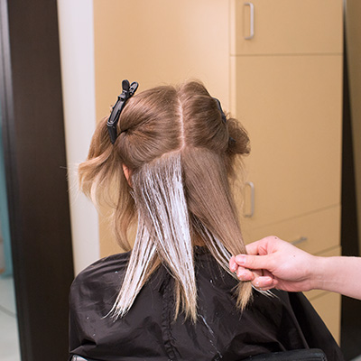 take alternating diagonal-back and diagonal-forward partings, working the product onto the surface of the hair