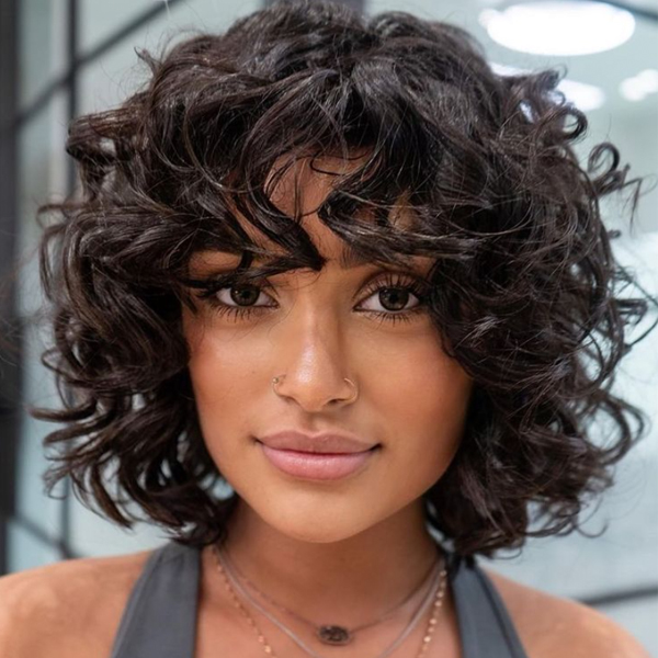 curly short shag haircut curtain bangs 2022 hair trend forecast predictions celebrity stylists best haircut trends