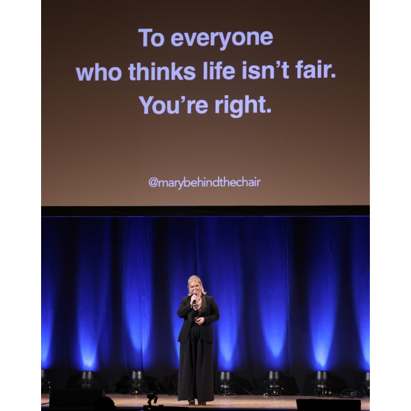 Mary Rector at the Orpheum Theatre in Los Angeles, California giving a motivational business presentation with tips on management, AI and social media for hairdressers.