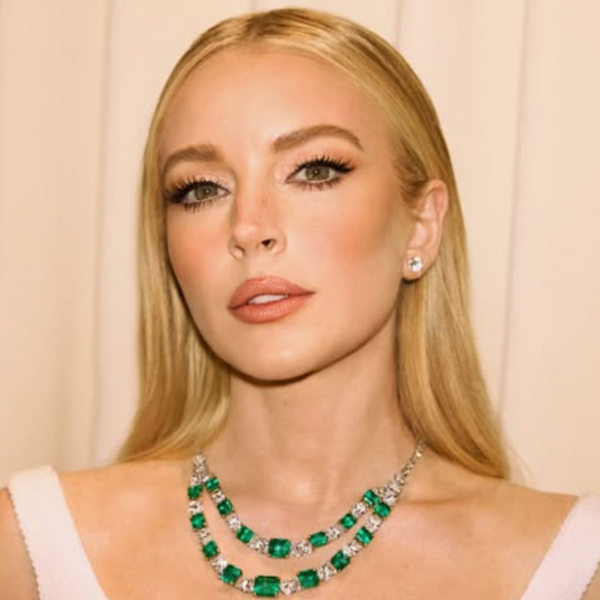 Lindsay Lohan at the 2025 Vanity Fair Oscars Party with sleek, soft waves in a white dress on the red carpet.