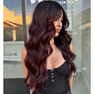 plum balayage on a model with long soft waves 